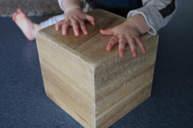 child and a wooden box
