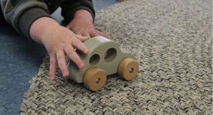 child playing with a car